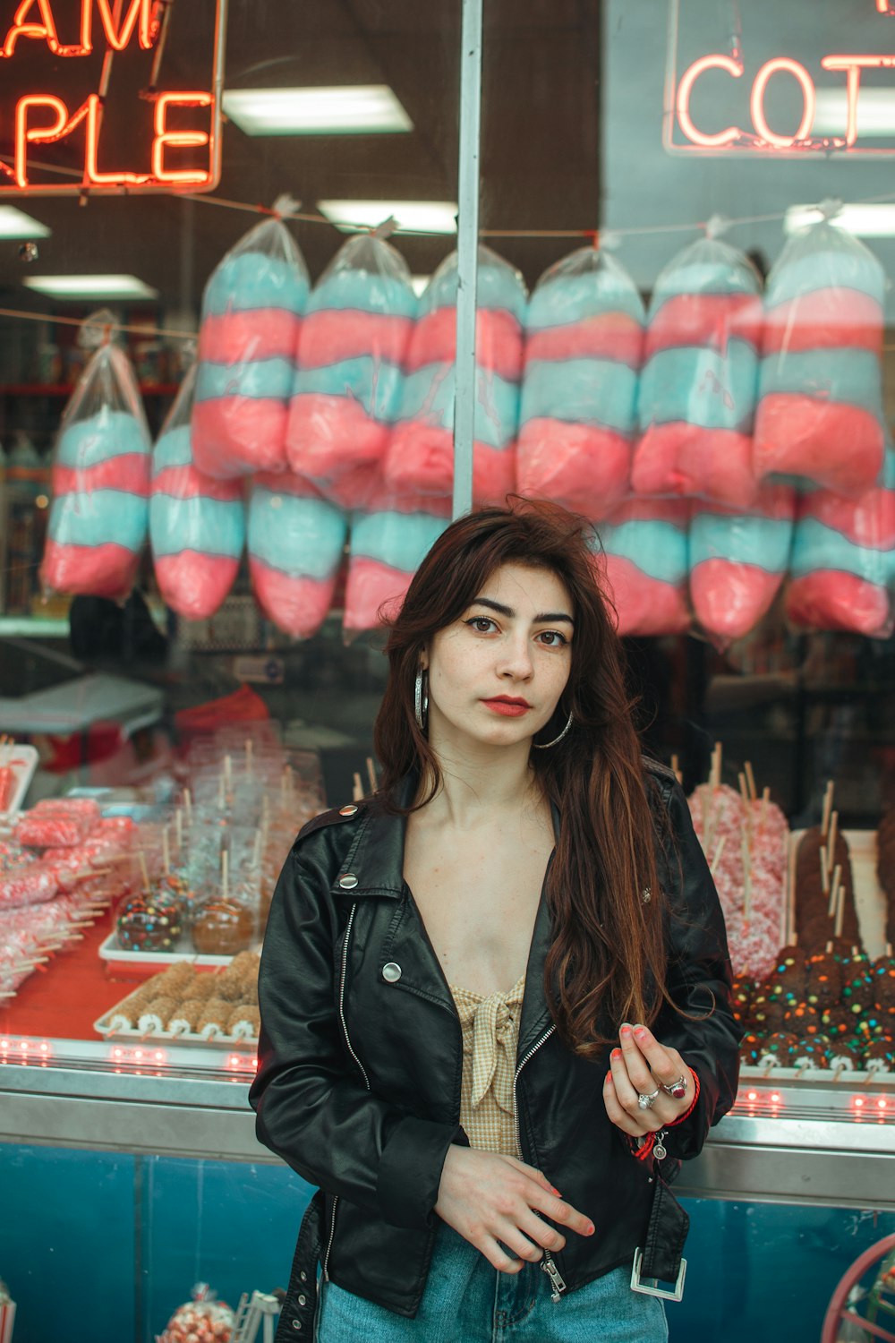 woman in black jacket standing near store