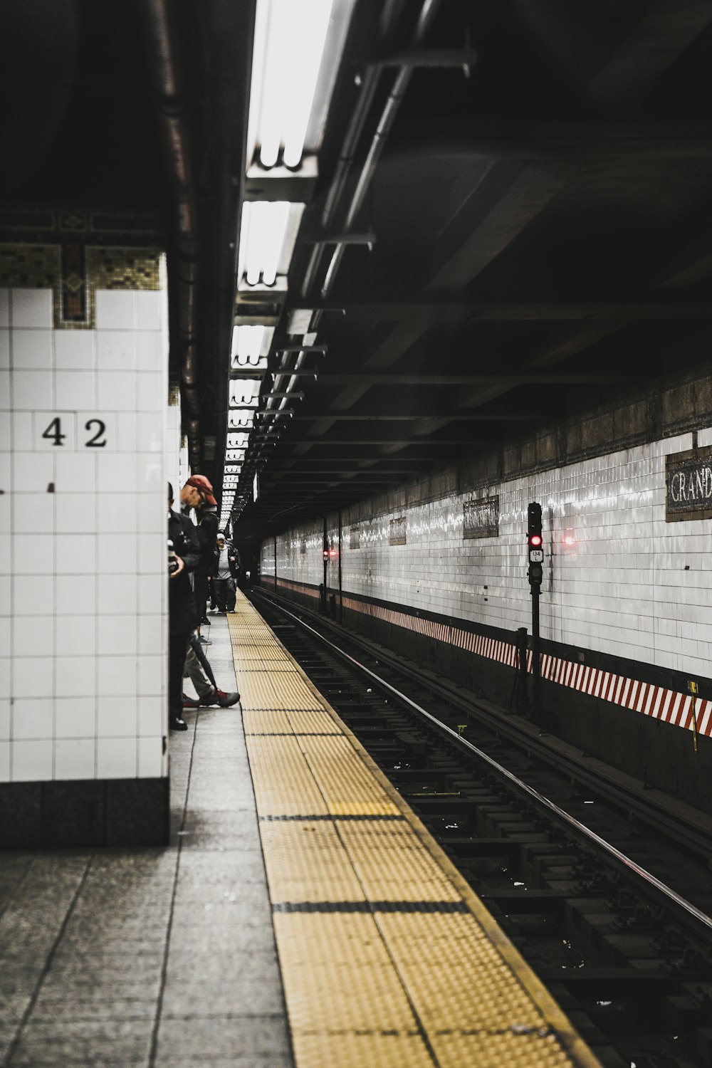 men standing by train station