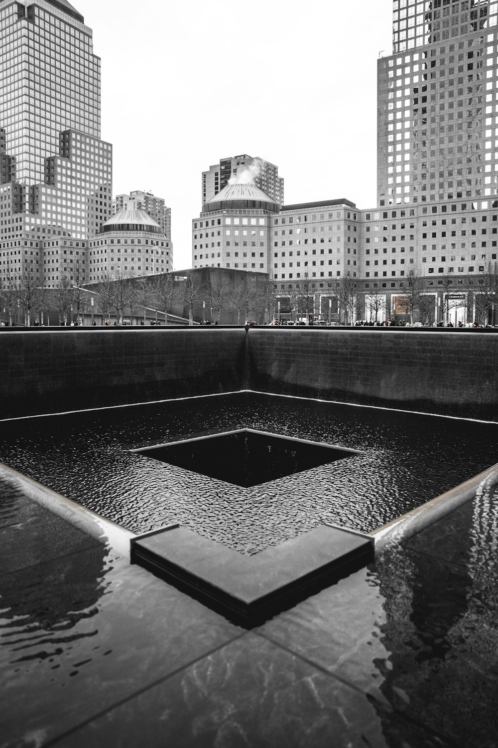 grayscale photography of empty fountain in the city