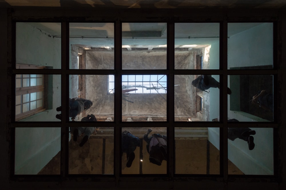 people walking on glass surface inside building