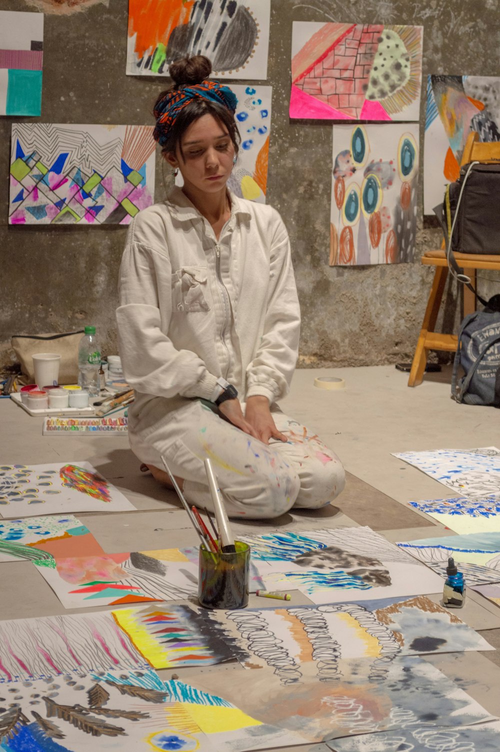 woman sitting near painting lot