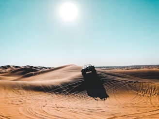 vehicle on desert during daytime