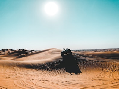 vehicle on desert during daytime