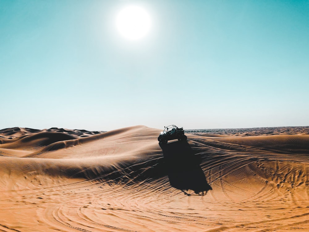 vehicle on desert during daytime