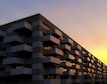 Contemporary apartment building facade at sunset