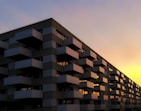 Contemporary apartment building facade at sunset