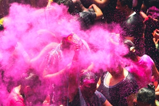 people using purple holi powder