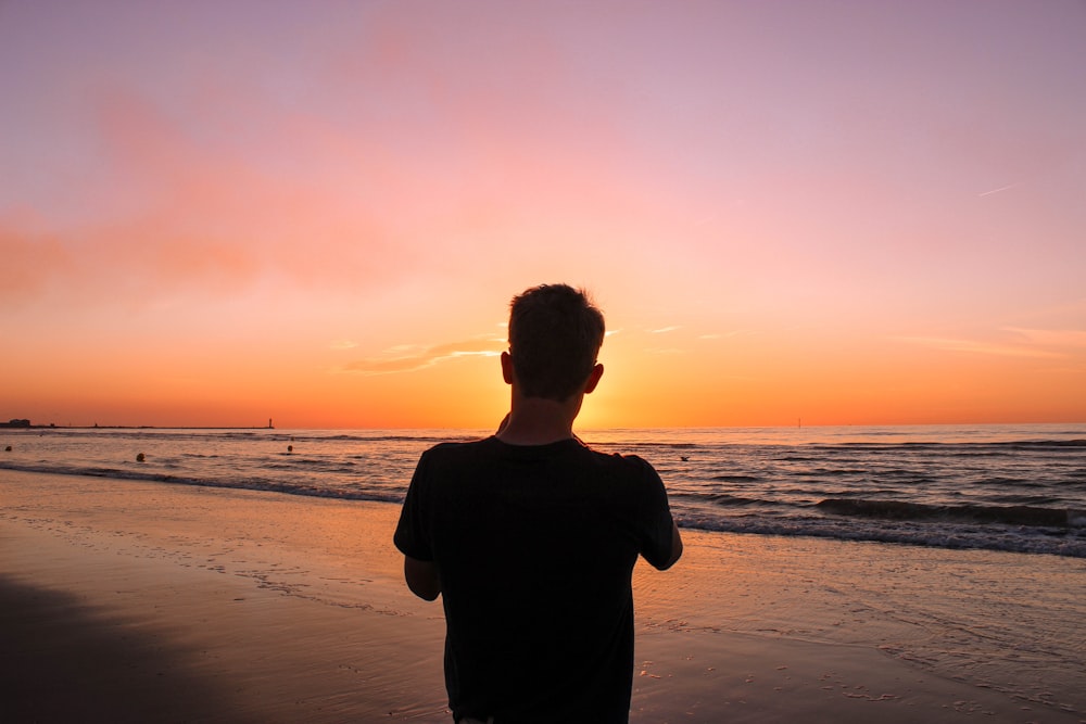 man facing sea during golden hour