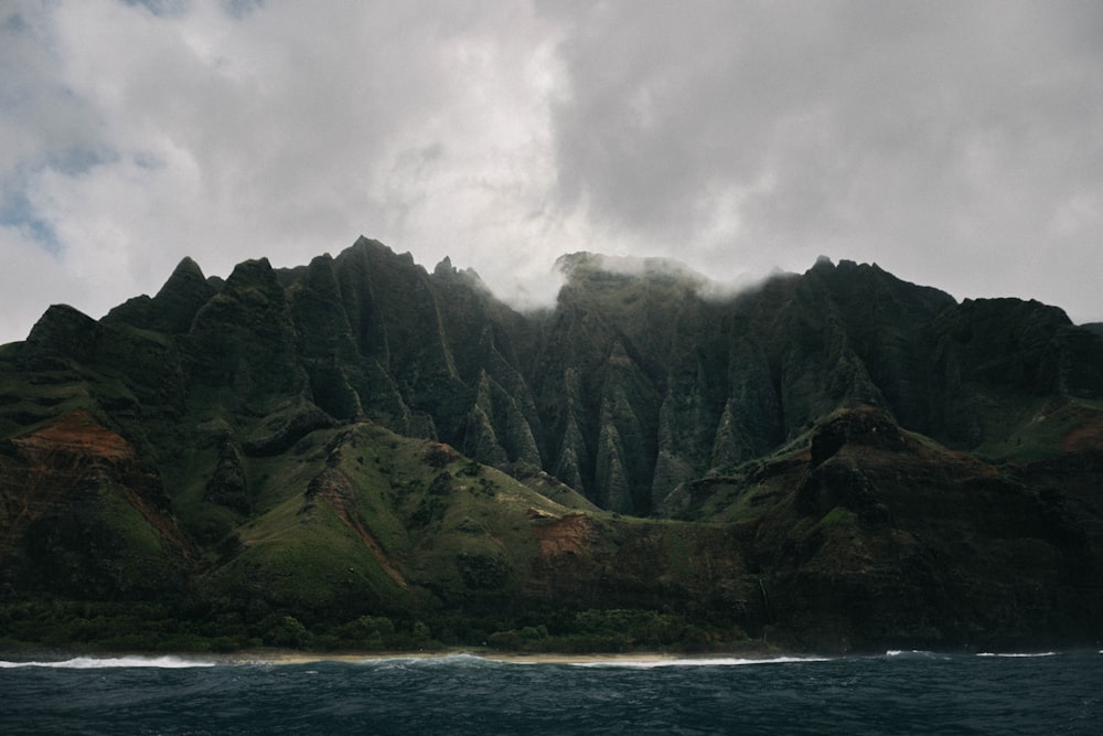 grey clouds hovering above mountain island