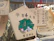 Wooden ema plaques are hanging, featuring Japanese characters and illustrations. One plaque prominently displays a drawing of a figure in traditional Japanese attire, with text written in Japanese around it.
