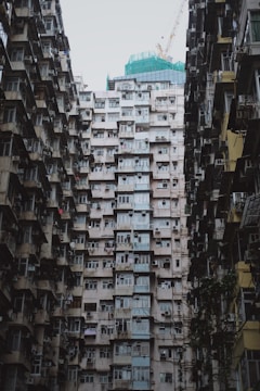 Wide shot of a high-rise apartment in Mumbai with freshly installed pigeon nets on all balconies.