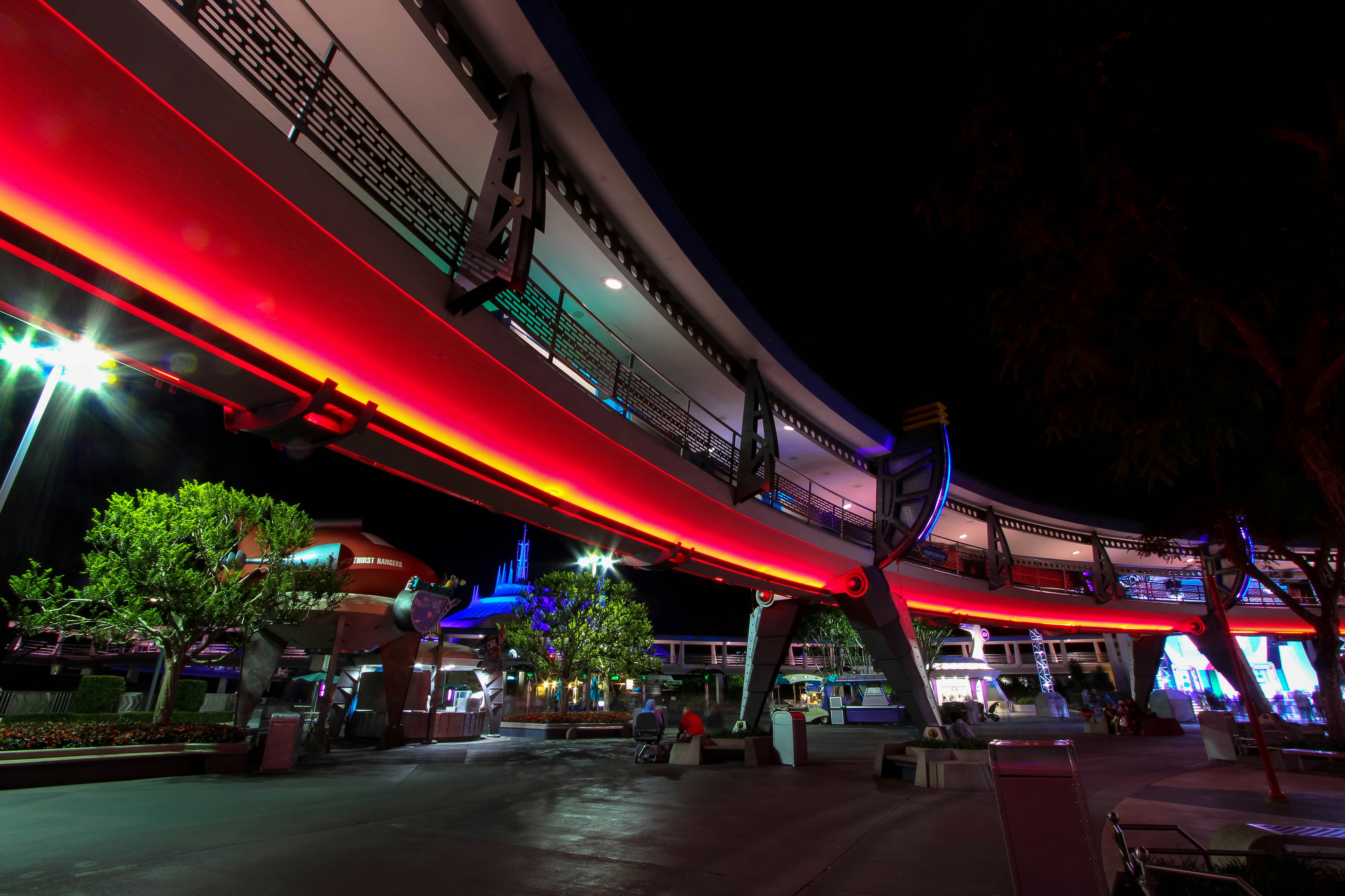 red neon lights lining the building tomorrowland teams background