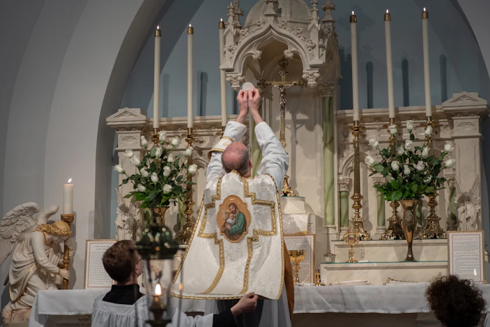 priest standing beside altar