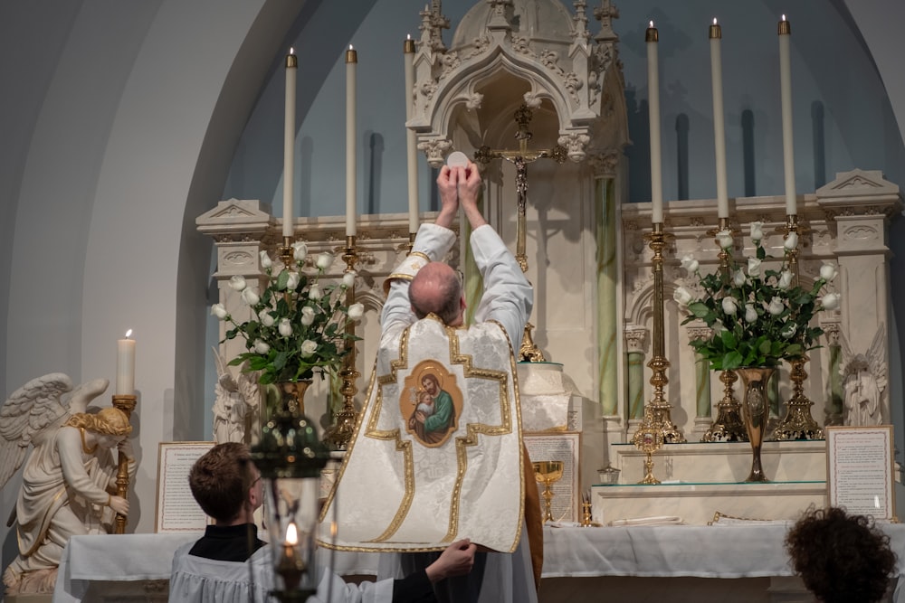 priest standing beside altar