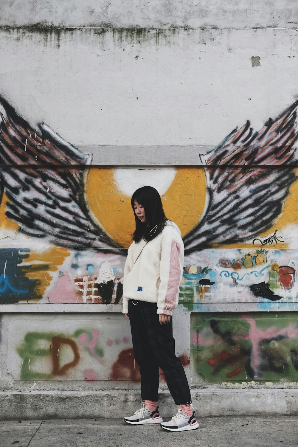 woman standing in front of concrete wall