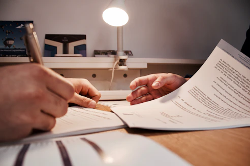 Professional consultant reviewing regulatory documents in a modern gas station office.