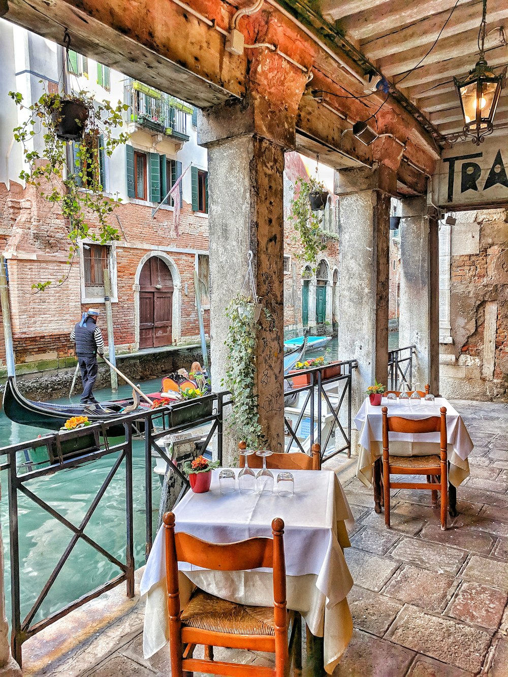 man riding on boat beside restaurant