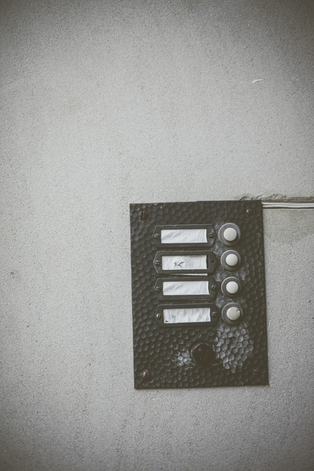 rectangular black and white wall switch during daytime