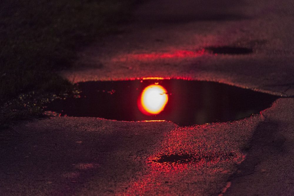 a red light shines in a hole in the ground