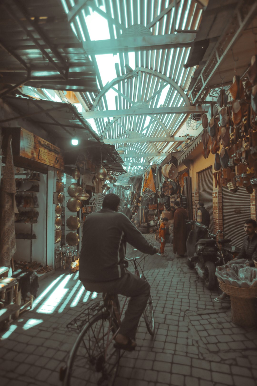 man riding bicycle between stores