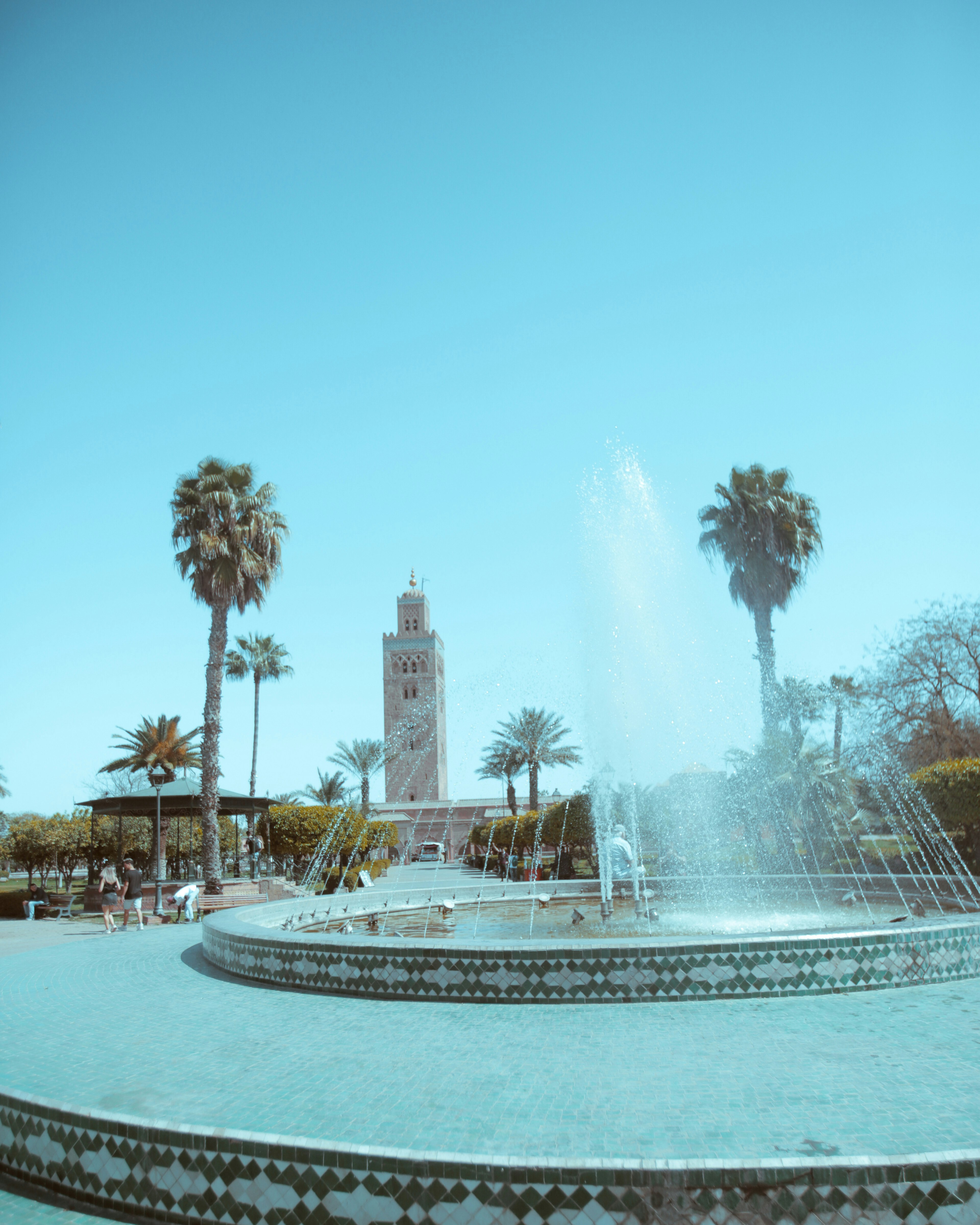 blue round park fountain under clear blue sky