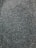 A close-up view of numerous small, dark seeds spread evenly across the entire frame.