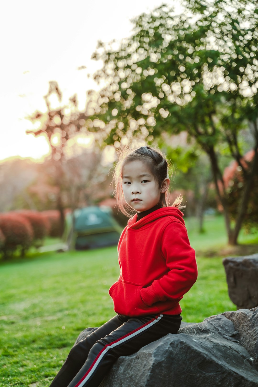 girl sitting on rock during daytime