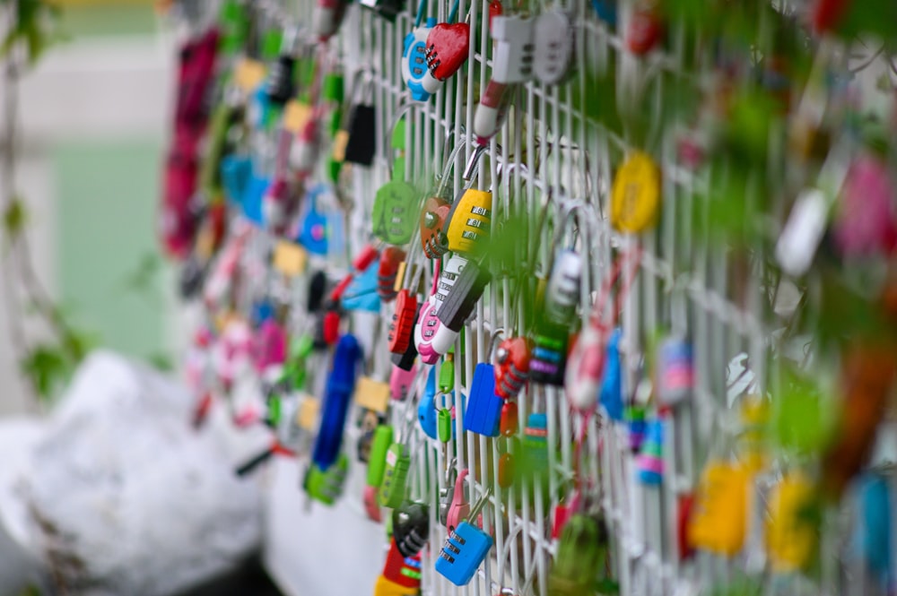 assorted-color padlocks on railing during daytime