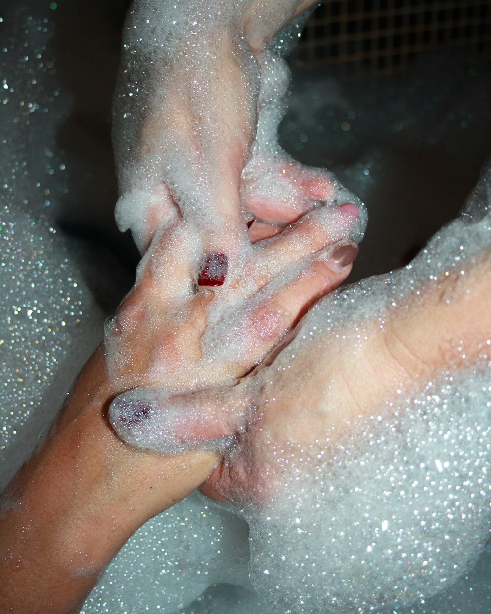 two person with bubbles on hands