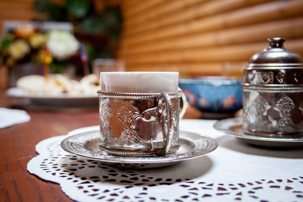 tissue in mug on saucer on place mat