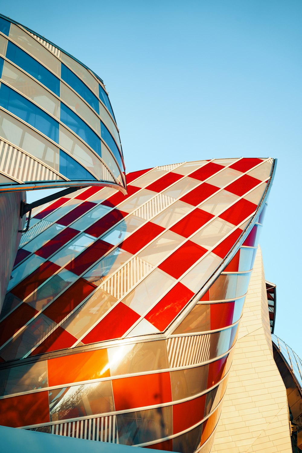 gray, red, and blue glassed building during daytime