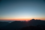 A scenic view of a mountain range at sunrise.