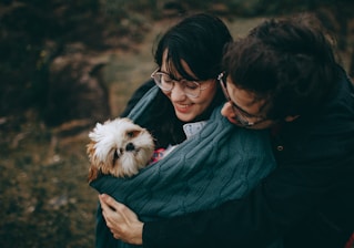 A joyful family welcoming a newly adopted dog into their home.