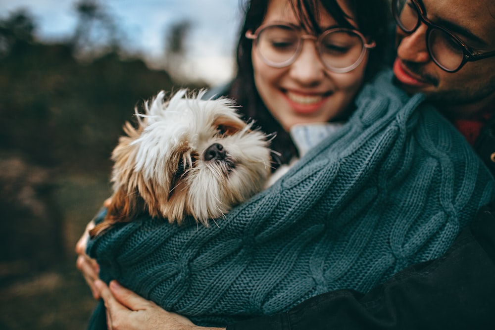 woman carrying dog