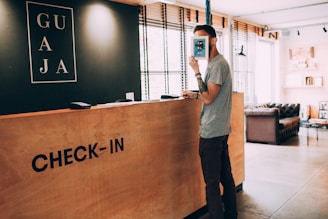 man standing beside counter