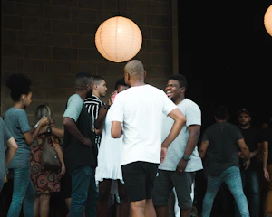 A warm gathering of diverse community members sharing stories under soft, glowing lights.