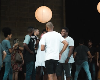 Evening event with warm lighting and guests enjoying casual conversations.