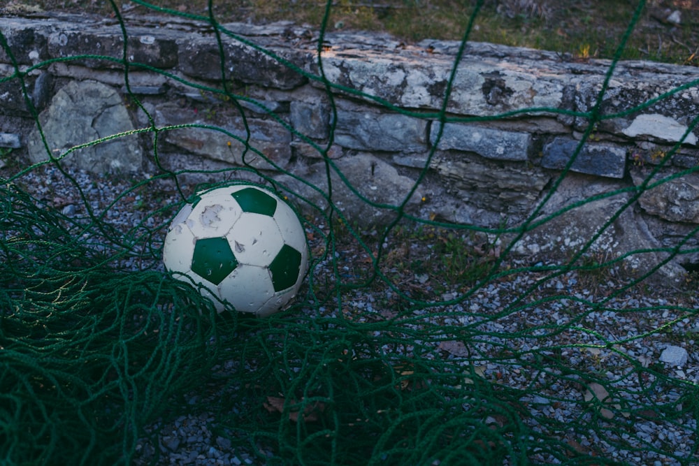 white and green soccer ball