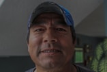 man wearing blue curve-brim cap