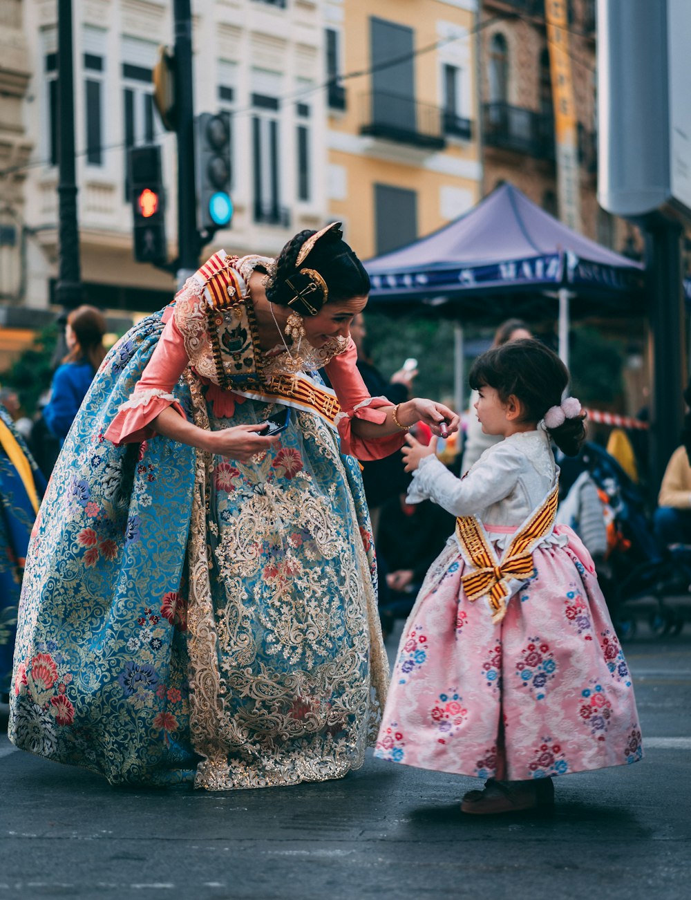 girl wearing pink dress in front of woman