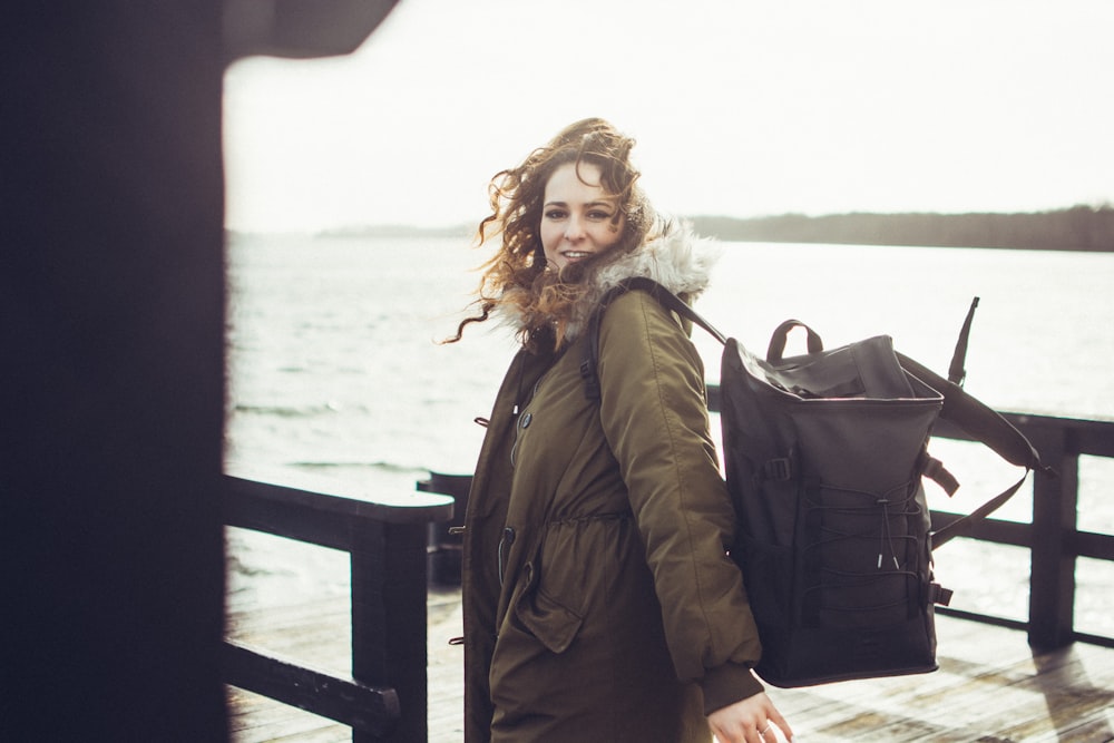 selective focus photography of woman carrying black backpack