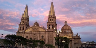 A magical sunset behind the Cathedral of Our Lady, highlighting its stunning spire.