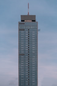 A completed commercial building standing tall against a clear blue sky.
