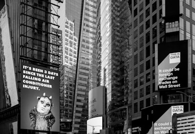 Panoramic view of a stock market ticker board in a busy financial district.