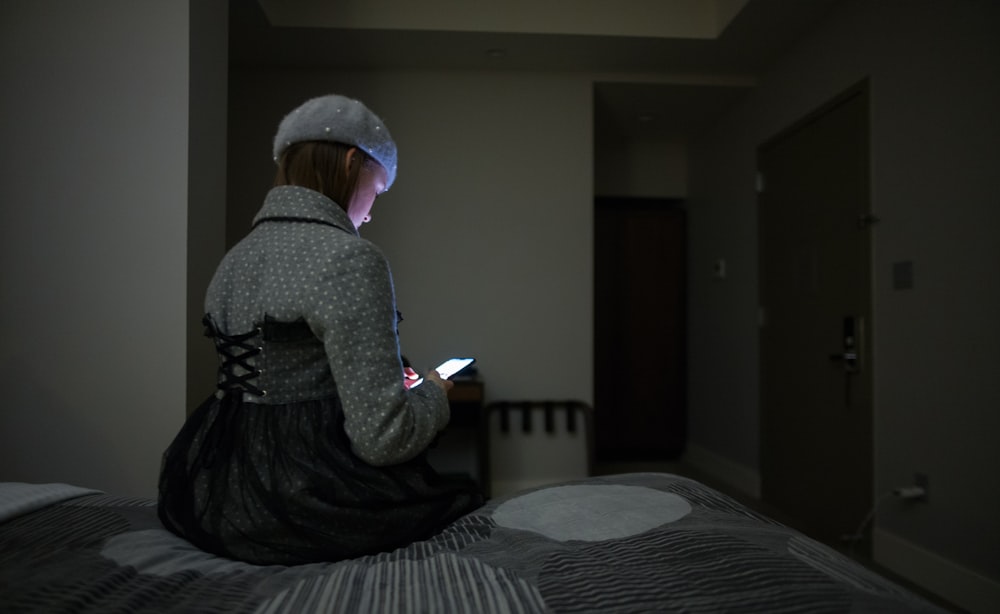 woman sitting on bed