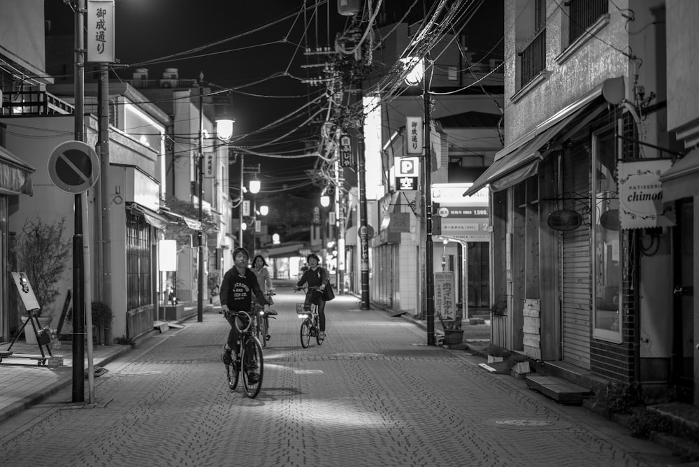 grayscale of person riding on bicycle