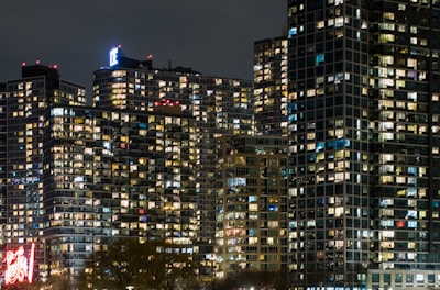 A nighttime cityscape with glowing windows, symbolizing global connections and dreams taking flight.