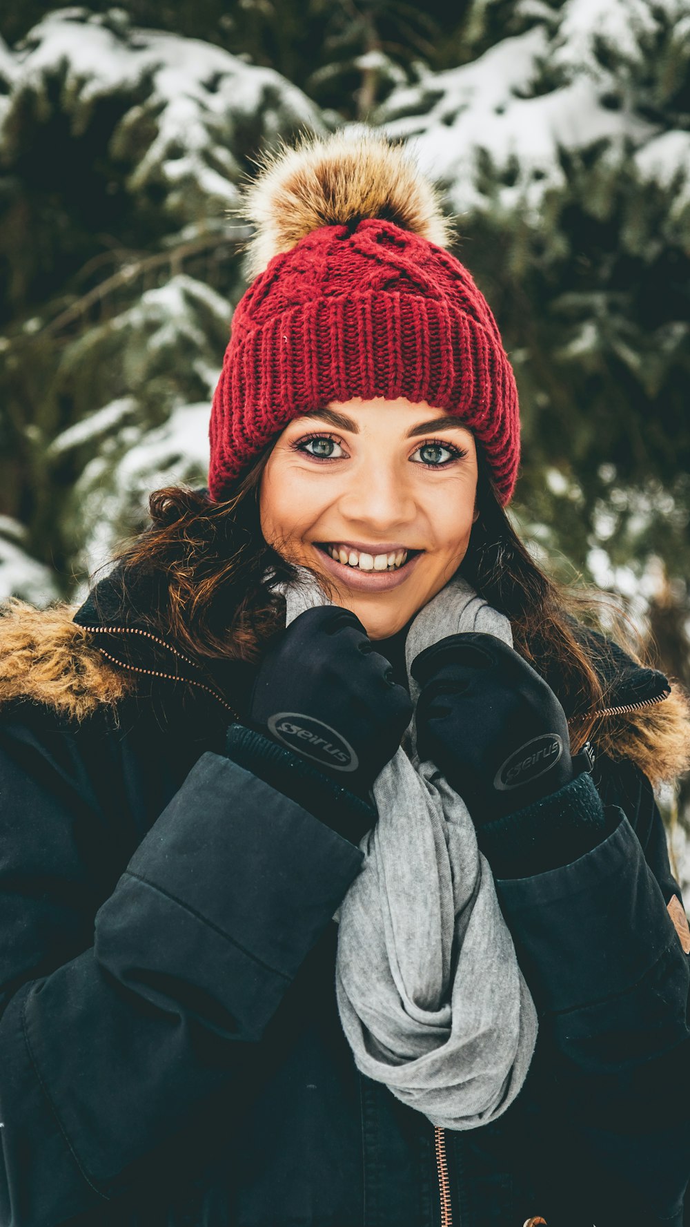 woman standing near trees covered by snow