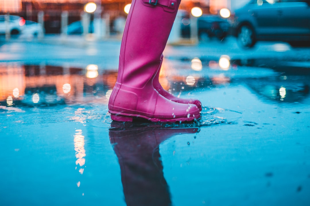 person wearing pink leather boots