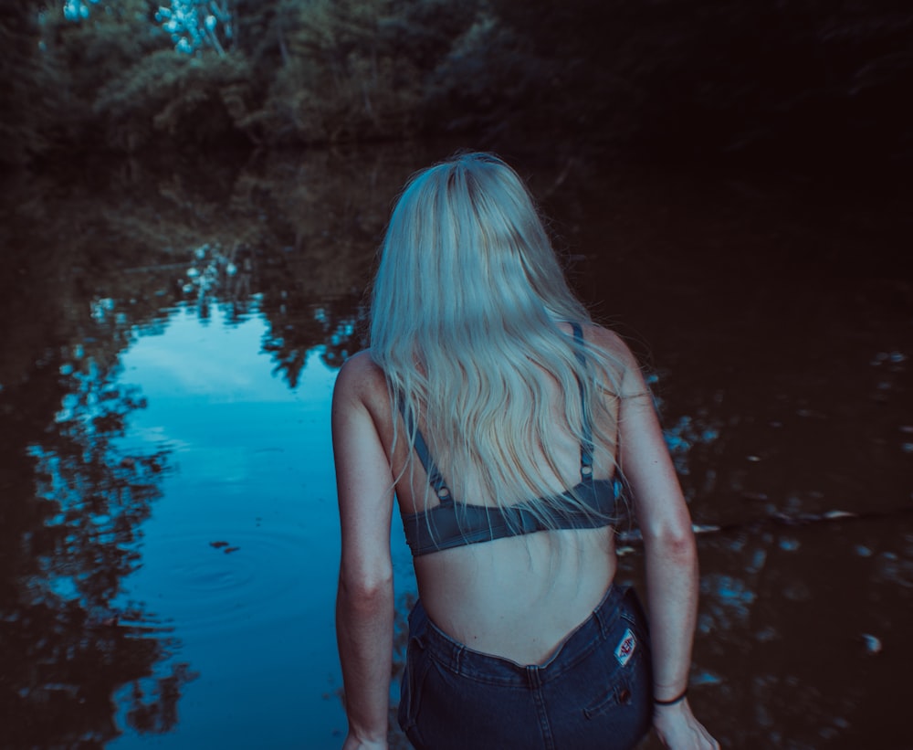 woman wearing gray bra and black pants